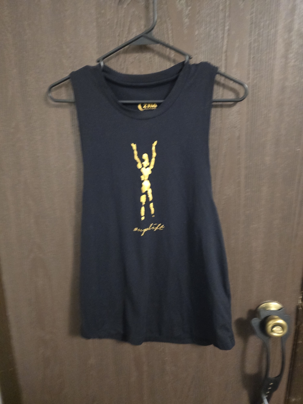 Zyia Active "Uplift" black tank top featuring a gold graphic print